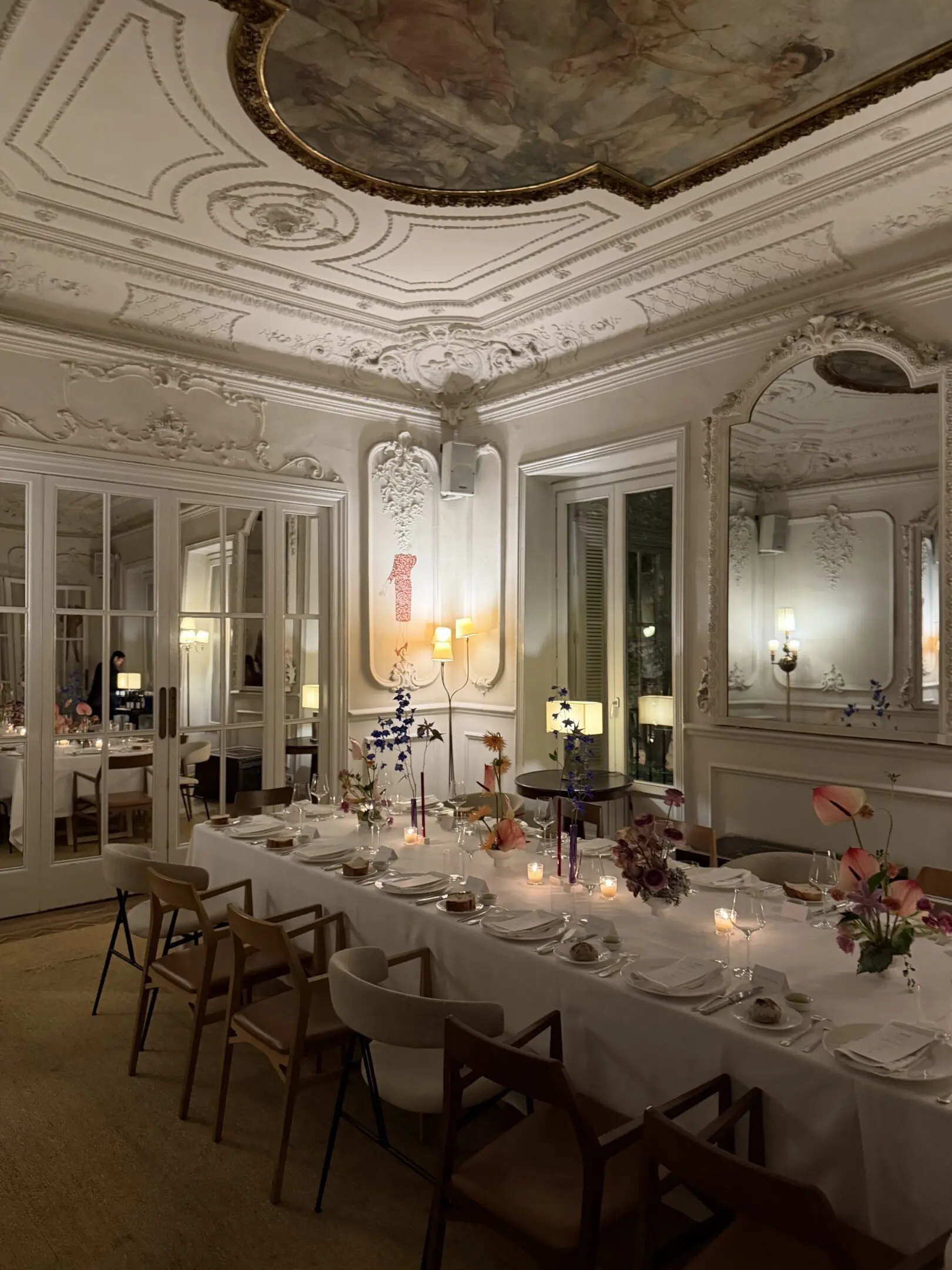 Ornate candlelit dining room with long table