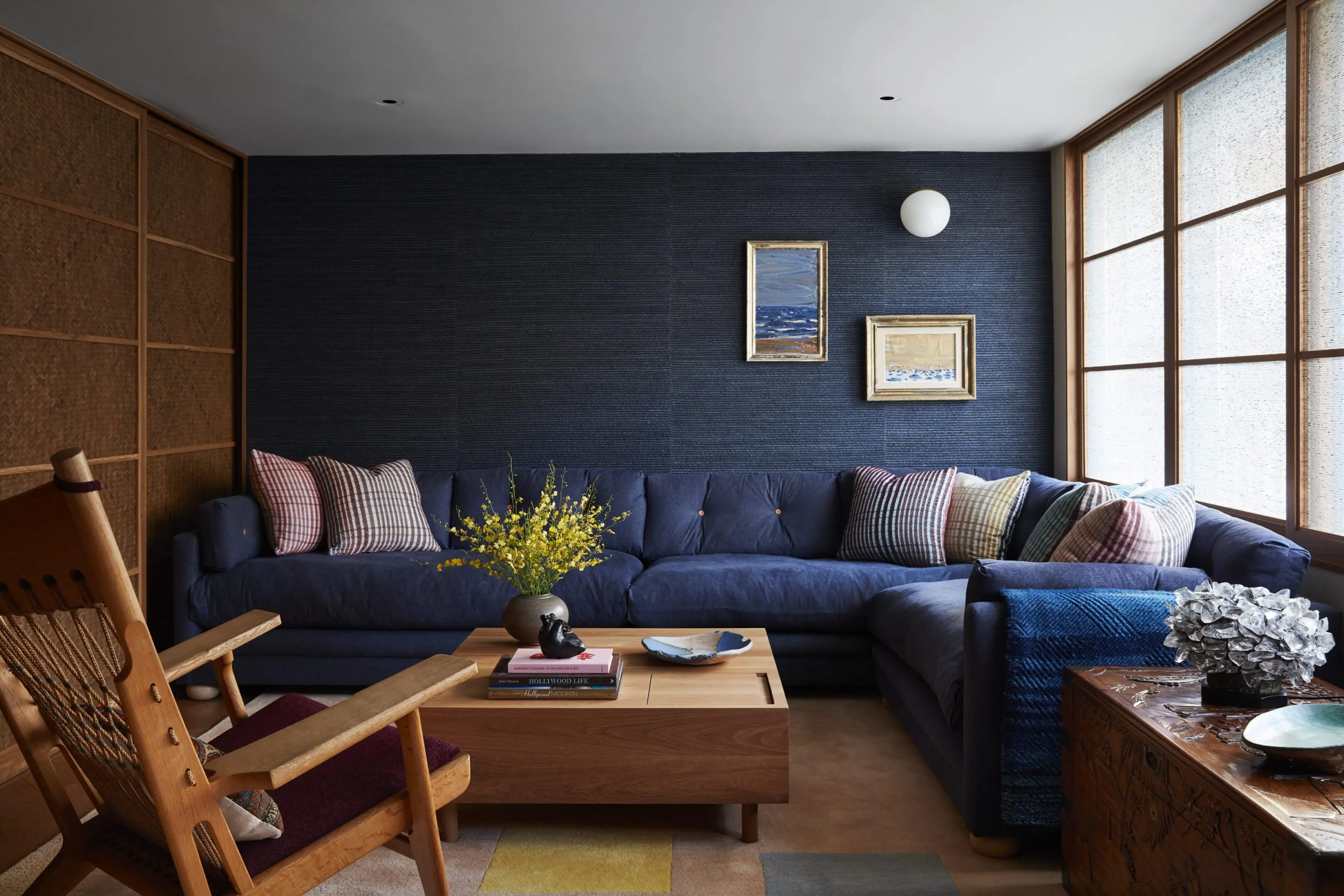 Cozy navy sectional living room with wooden accents