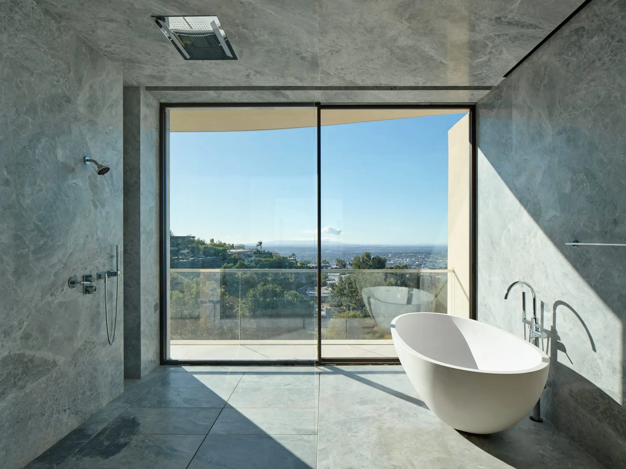 Modern bathroom with freestanding tub and ocean view